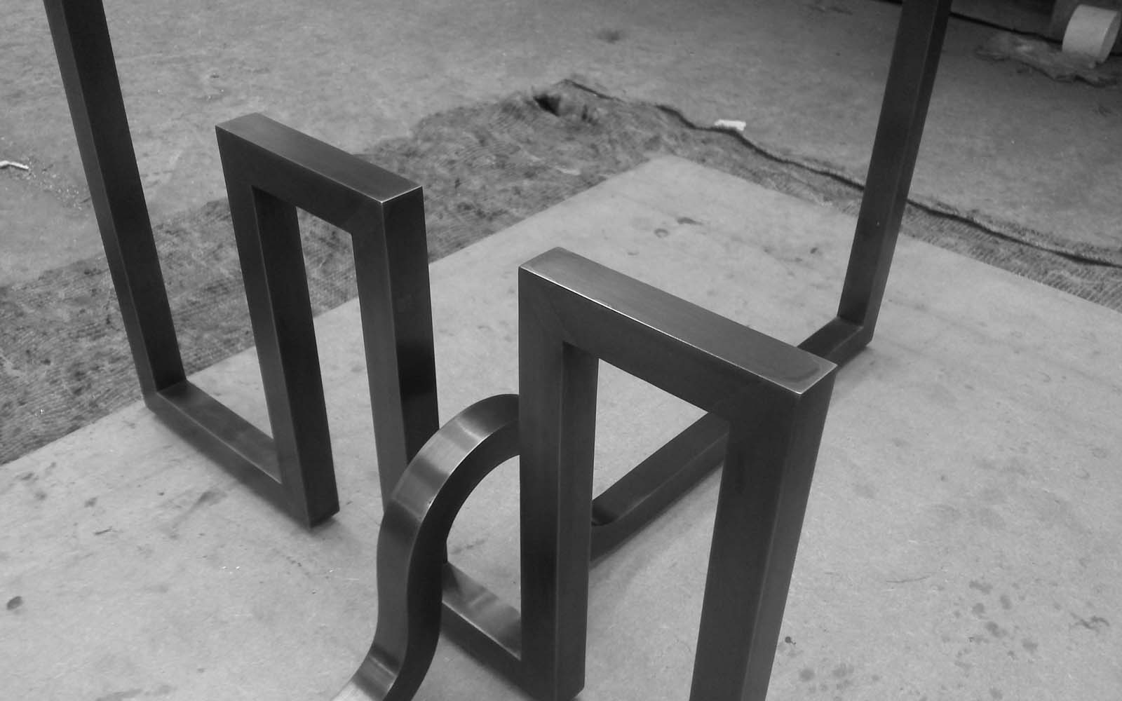 Escher-style metalwork forming table support